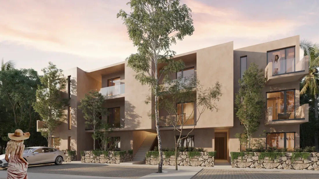 Naraina Akumal — fachada de departamentos entre árboles al atardecer